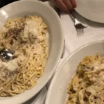 Plates of classic Roman pasta in a trattoria